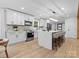 Modern kitchen featuring white cabinets, a marble island with bar seating, and stainless steel appliances at 3417 Chilham Pl, Charlotte, NC 28226
