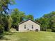 View of the home's exterior showcasing the lawn, siding, and backyard at 379 Maiden Sw Ln, Concord, NC 28025