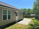 Backyard featuring siding, patio, a back door, and lawn at 379 Maiden Sw Ln, Concord, NC 28025
