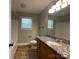 Bathroom showcasing a vanity with granite countertops, tile flooring, and a window at 379 Maiden Sw Ln, Concord, NC 28025