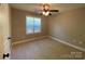 Bedroom showcasing a window with blinds, ceiling fan, and neutral carpet at 379 Maiden Sw Ln, Concord, NC 28025