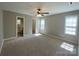 Spacious bedroom with a ceiling fan, two windows, and adjoining bathroom and walk-in closet at 379 Maiden Sw Ln, Concord, NC 28025