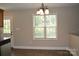 Eat-in kitchen area featuring natural light, hardwood flooring, and stainless-steel appliances, with a walk-in pantry and laundry at 379 Maiden Sw Ln, Concord, NC 28025