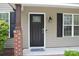 Close-up of the black front door with glass detailing and brick pillar at 379 Maiden Sw Ln, Concord, NC 28025