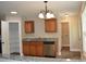 Well-equipped kitchen featuring granite countertops, wooden cabinets, and stainless steel appliances for modern convenience at 379 Maiden Sw Ln, Concord, NC 28025