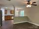 Open-concept living area with hardwood floors flowing into the kitchen, great for entertaining at 379 Maiden Sw Ln, Concord, NC 28025