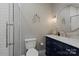 Stylish bathroom featuring a glass-enclosed shower and blue vanity with a marble countertop at 4039 5Th Nw St, Hickory, NC 28601