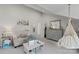 Cozy bedroom features a gray dresser, sitting area and a hanging hammock chair at 4039 5Th Nw St, Hickory, NC 28601
