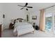 Bedroom features a plush bed, ceiling fan and sliding glass doors to the outside at 4039 5Th Nw St, Hickory, NC 28601