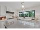 Well-lit kitchen featuring a farmhouse sink, subway tile backsplash, stainless appliances, and large window with views at 4039 5Th Nw St, Hickory, NC 28601