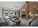 Inviting living room featuring a stone fireplace, large windows with lake views, and comfortable seating at 4039 5Th Nw St, Hickory, NC 28601