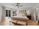 A bright bedroom features a large, tufted bed with two benches and a ceiling fan at 4039 5Th Nw St, Hickory, NC 28601