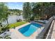 Beautiful pool overlooking the lake with an umbrella table and lounge chairs for relaxation at 4039 5Th Nw St, Hickory, NC 28601