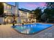 Backyard with a pool, patio, and an outdoor dining area. The home has balconies and large windows at 4039 5Th Nw St, Hickory, NC 28601