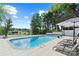Enjoy a private backyard with a large pool and multiple lounge chairs by the lake at 4039 5Th Nw St, Hickory, NC 28601