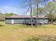 The backyard has a metal roof home, green siding, and a raised wood deck at 4115 Conley St, Newton, NC 28658