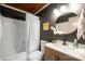 Cozy bathroom has a shower-tub combination, stylish vanity, and round mirror at 4115 Conley St, Newton, NC 28658