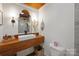 The bathroom features a wood counter with vessel sink, custom mirror, modern lighting, toilet, and basket at 4115 Conley St, Newton, NC 28658