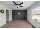 Bedroom features modern accent wall, ceiling fan, and wood-look flooring at 4115 Conley St, Newton, NC 28658