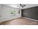 This bedroom offers wood floors, a ceiling fan, a window view, and stylish wainscoting at 4115 Conley St, Newton, NC 28658