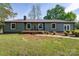 Charming single-story home with a well-manicured front yard, wood deck, and neutral toned siding at 4115 Conley St, Newton, NC 28658
