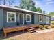 Charming home with a wooden deck, gray siding, white trim, and a welcoming front entrance at 4115 Conley St, Newton, NC 28658