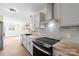 Bright kitchen with white cabinets, stainless steel appliances, butcher block countertops, and decorative shelves at 4115 Conley St, Newton, NC 28658