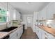 Modern kitchen featuring white cabinets, butcher block countertops, and stainless steel appliances at 4115 Conley St, Newton, NC 28658