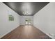 Bright living room with hardwood floors, modern light fixture, and window views at 4115 Conley St, Newton, NC 28658