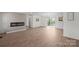 Open living room with hardwood floors, modern fireplace, and natural light from sliding glass doors at 4115 Conley St, Newton, NC 28658