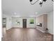 Spacious living room with hardwood floors, a modern fireplace, and natural light from large windows at 4115 Conley St, Newton, NC 28658