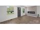 Bright living room with modern electric fireplace, windows, and wood-look flooring at 4115 Conley St, Newton, NC 28658