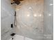 Modern bathroom shower with gray and white tiles, a built-in seat, and black fixtures at 4115 Conley St, Newton, NC 28658