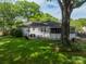 Expansive backyard featuring a screened porch, patio area, and mature trees at 4544 Craig Ave, Charlotte, NC 28211