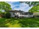 Private backyard with a screened porch, perfect for outdoor dining and relaxation at 4544 Craig Ave, Charlotte, NC 28211