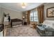 Charming Bedroom featuring a crib, comfortable chair, and cozy decor creates a warm and inviting space for a baby at 4544 Craig Ave, Charlotte, NC 28211