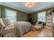 Stylish bedroom featuring hardwood floors, an accent wall, and a cozy seating area is perfect for relaxation and rest at 4544 Craig Ave, Charlotte, NC 28211