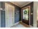 Inviting entryway with a stylish front door, textured wallpaper, and wood floors at 4544 Craig Ave, Charlotte, NC 28211