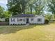 Quaint single-story home with a traditional design and lush green front lawn at 4544 Craig Ave, Charlotte, NC 28211
