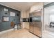 Kitchen boasts stainless steel refrigerator, white cabinets, and tile flooring at 4544 Craig Ave, Charlotte, NC 28211