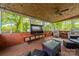 Comfortable screened porch featuring wicker furniture and TV is perfect for relaxation and enjoying the surrounding nature at 4544 Craig Ave, Charlotte, NC 28211