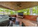 Inviting screened porch with wood floors and ceilings offers a comfortable outdoor living space and wooded views at 4544 Craig Ave, Charlotte, NC 28211