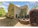Spacious backyard featuring a patio with fire pit, grill, and seating, great for outdoor entertaining at 4861 Samuel Pinckney Dr, Belmont, NC 28012