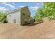 Home with a large backyard, featuring a patio area with a built-in fire pit, ideal for outdoor entertaining at 4861 Samuel Pinckney Dr, Belmont, NC 28012
