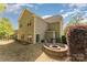 Spacious backyard featuring a patio with fire pit, grill, and seating, great for outdoor entertaining at 4861 Samuel Pinckney Dr, Belmont, NC 28012