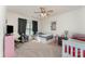 Bright bedroom featuring neutral carpeting, ceiling fan, and ample natural light from the window with dark curtains at 4861 Samuel Pinckney Dr, Belmont, NC 28012