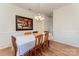 Well-lit dining room with hardwood floors, wainscoting, and a charming painting at 4861 Samuel Pinckney Dr, Belmont, NC 28012