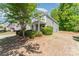 Charming two-story home featuring gray siding, a covered porch with white columns, and lush landscaping at 4861 Samuel Pinckney Dr, Belmont, NC 28012