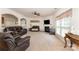 Airy living room featuring plush leather seating, fireplace, and an archway leading to the kitchen at 4861 Samuel Pinckney Dr, Belmont, NC 28012