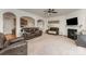 Spacious living room with comfortable leather furniture, fireplace, and open layout to the kitchen at 4861 Samuel Pinckney Dr, Belmont, NC 28012